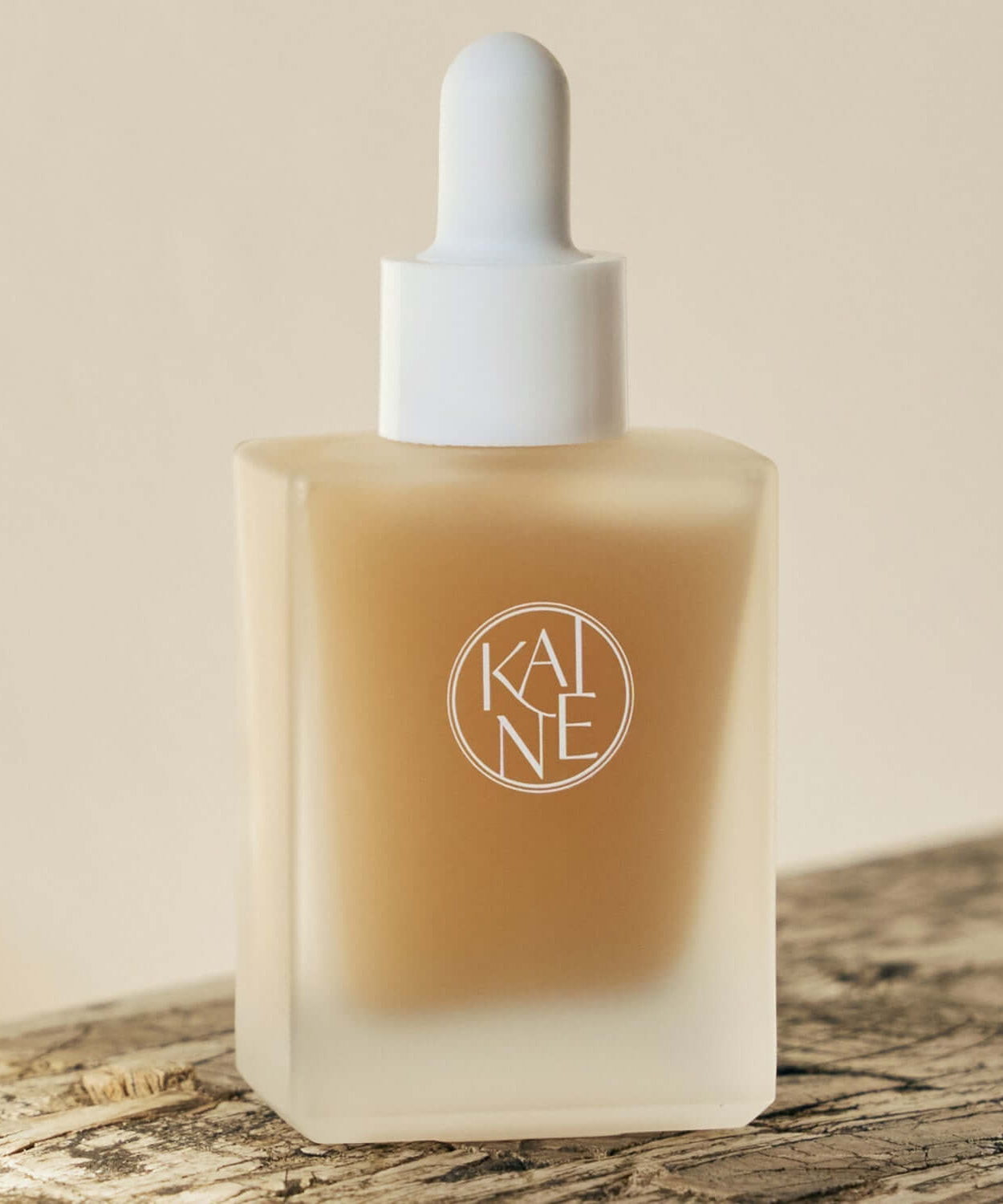 KAINE Kombu Barrier Ampoule in a glass bottle with dropper on a wooden surface