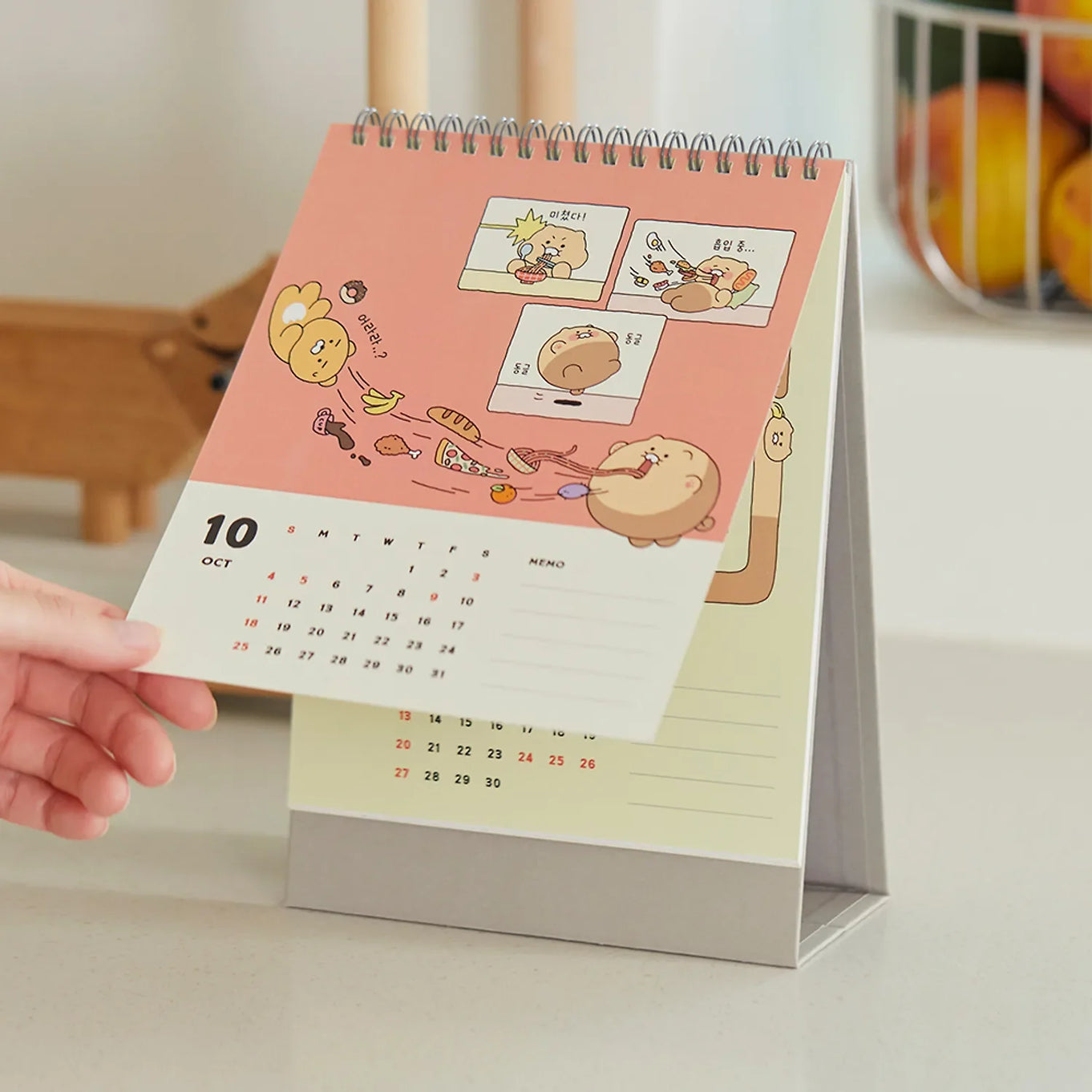 KAKAO FRIENDS Desk Calendar 2026 with cartoon characters on October page in a kitchen setting