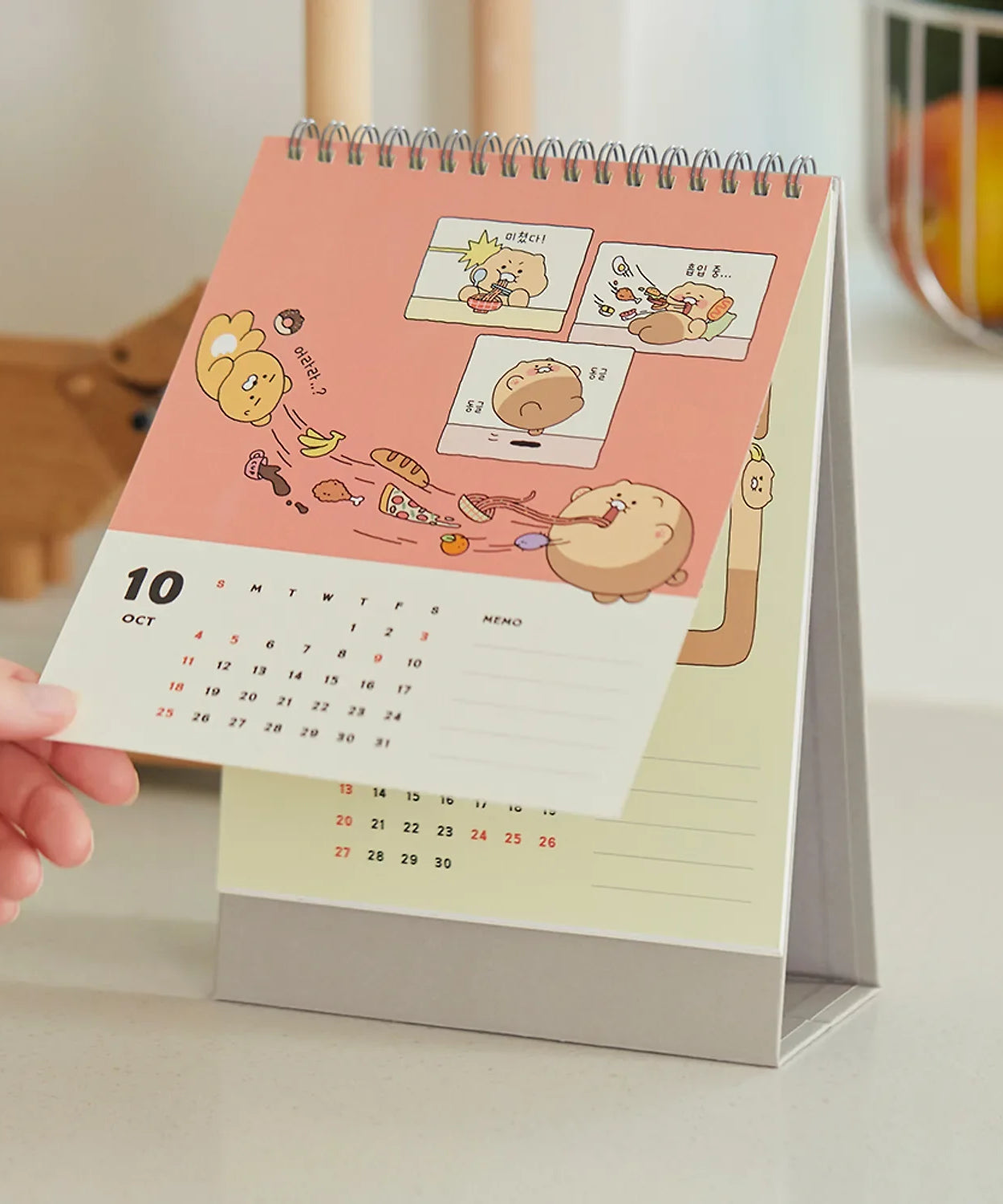 KAKAO FRIENDS Desk Calendar 2026 with cartoon characters on October page in a kitchen setting