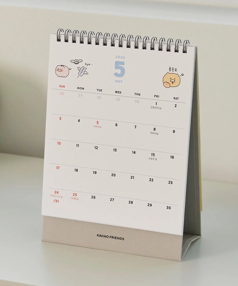 KAKAO FRIENDS Desk Calendar 2026 displayed on a white desk, showing the month of May with cartoon characters on the top.