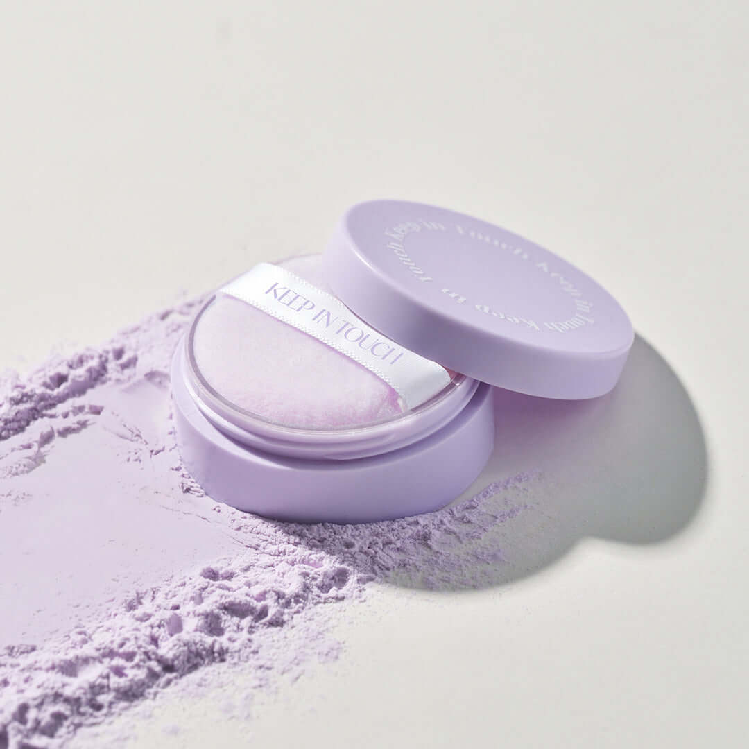 KEEP IN TOUCH Mini Pore Eraser Powder in lavender packaging with open cap and visible powder puff.