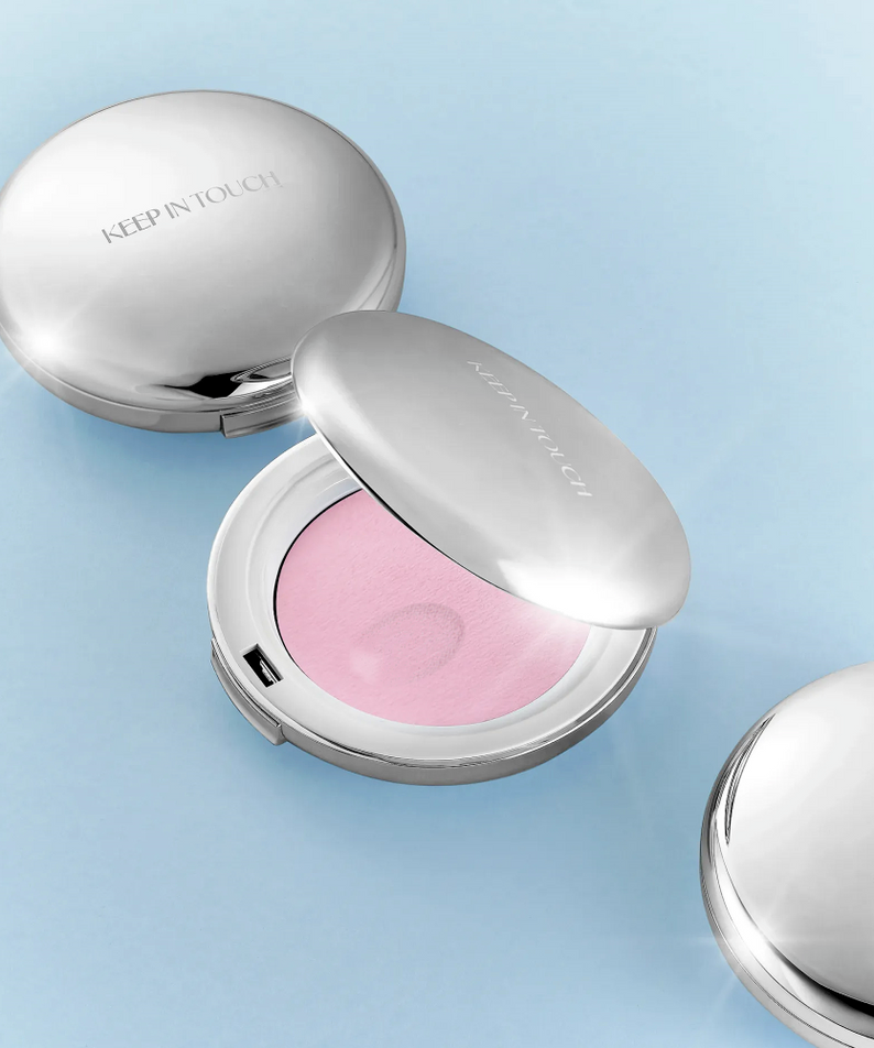 KEEP IN TOUCH Soft Cloud Blur Powder Pact in silver compact with open lid displaying pink powder.