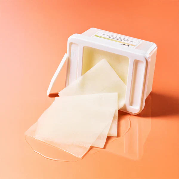 KLAIRS Freshly Juiced Vitamin Hwajalmeok Pad 80 sheets displayed on an orange background, showcasing the pads and packaging.