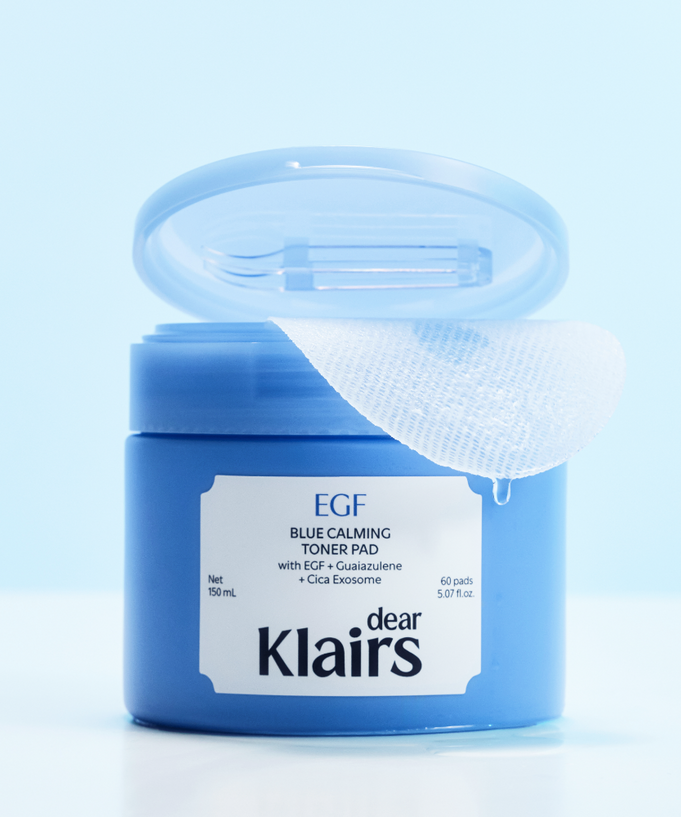 KLAIRS EGF Blue Calming Toner Pads 60 Pads jar with open lid, showcasing toner pad texture and product details on a light blue background.