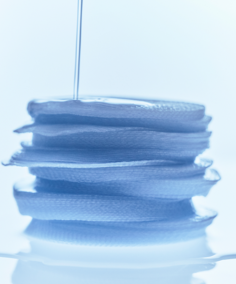 Stack of KLAIRS EGF Blue Calming Toner Pads 60 Pads with liquid being poured