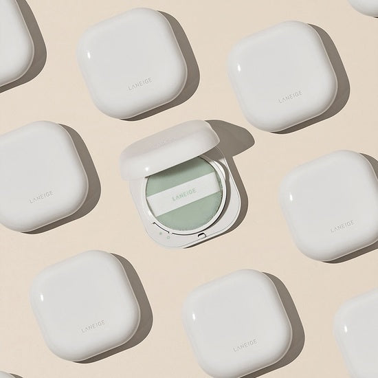 LANEIGE Neo Essential Blurring Finish Powder in white compact with makeup sponge, displayed among similar containers on a beige background.