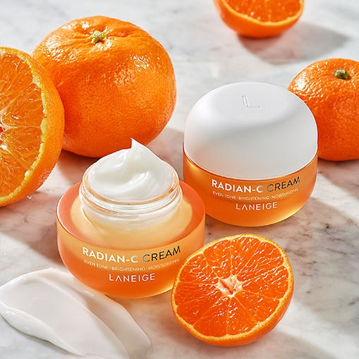 LANEIGE Radian-C Cream 30ml with citrus fruits, showcasing brightening moisturizer benefits in a 30ml jar on a marble surface.