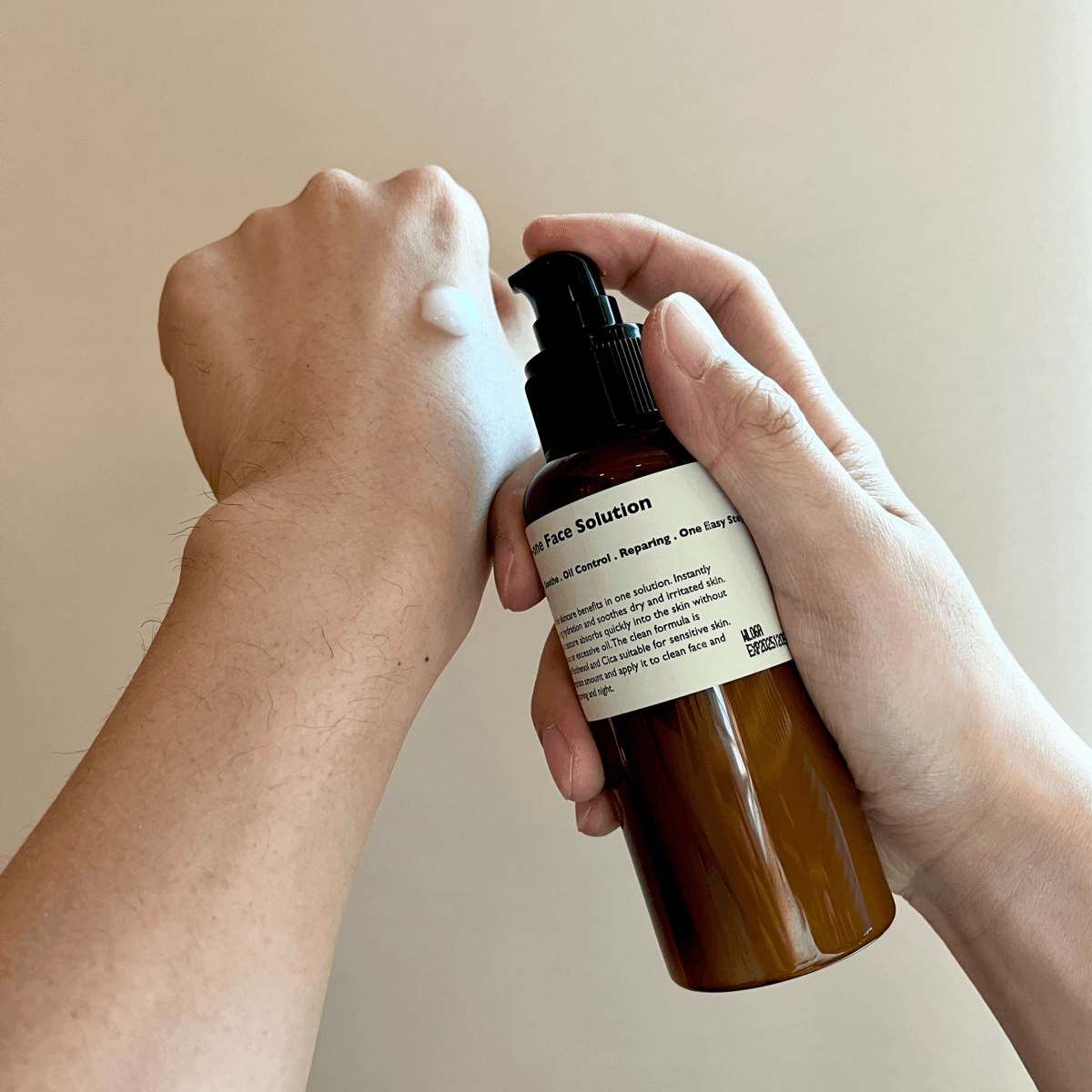 Gentleman Korea product shot: LAZY SOCIETY All-in-One Face Solution 150g pump dispensing cream on male hand for Korean men’s skincare