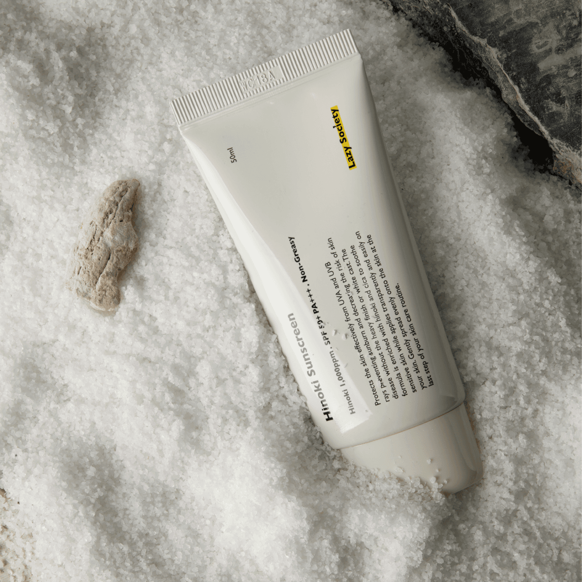 LAZY SOCIETY Hinoki Sunscreen SPPF 50+ PA+++ 50ml tube on textured white background, Korean men’s sunscreen from Gentleman Korea