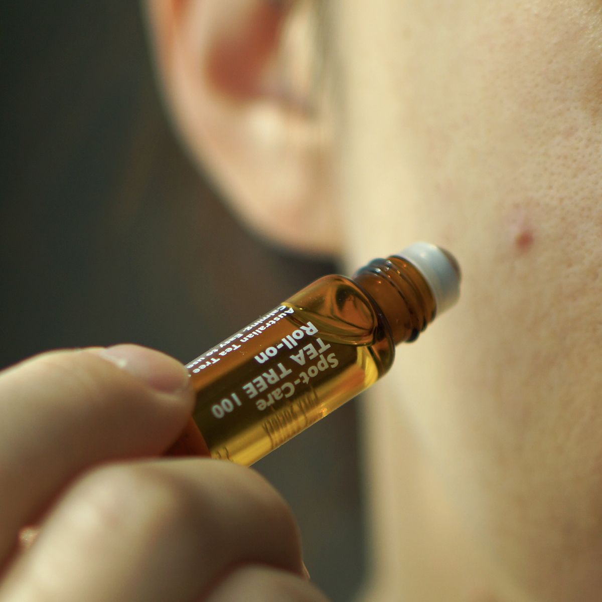 Gentleman Korea applying LAZY SOCIETY Spot Care Tea Tree 100 Roll on 5.5ml to a facial blemish for men’s skincare