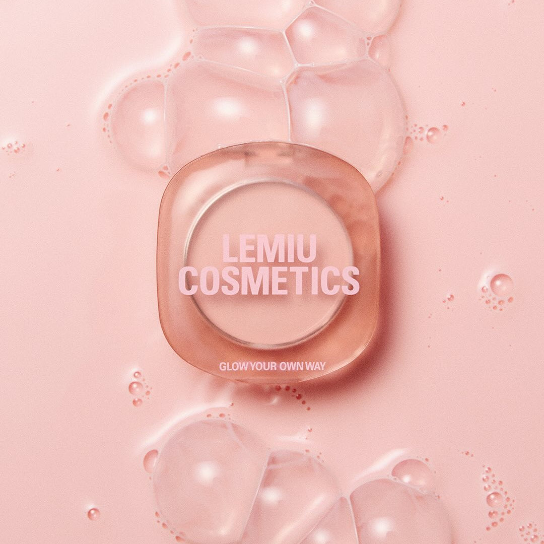LEMIU Eye To Cheek compact on pink background with bubbles, LEMIU COSMETICS branding visible, promoting product versatility.