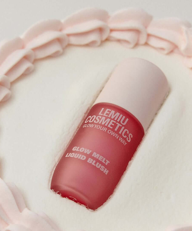 LEMIU Glow Melt Liquid Blush bottle in soft pink setting, showcasing the elegant cosmetic packaging and vibrant blush hue.