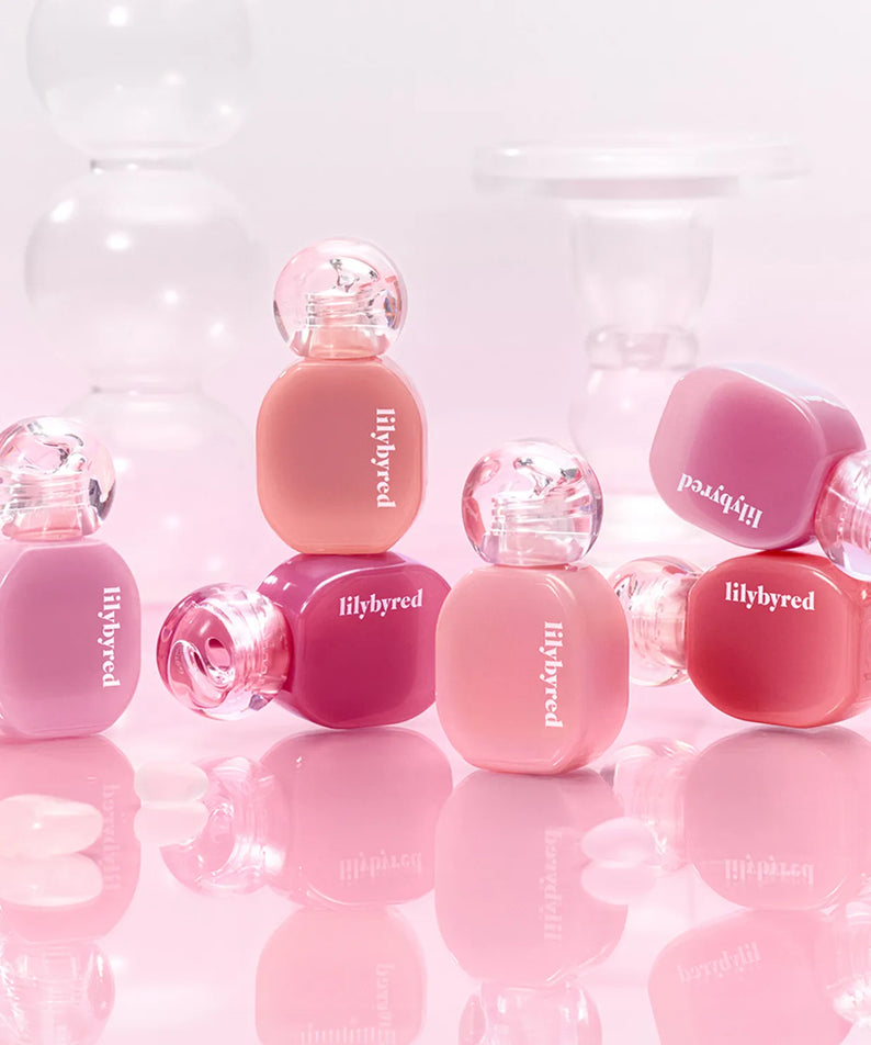 LILYBYRED Balming Dewy Tint bottles in various shades with pink background, showcasing vibrant lip tint options.