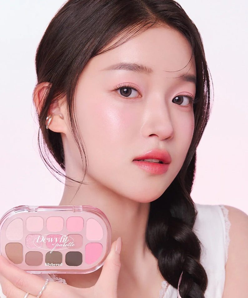 Woman holding LILYBYRED Dewy Fit Palette, featuring a range of soft pink and neutral shades for a dewy makeup look.