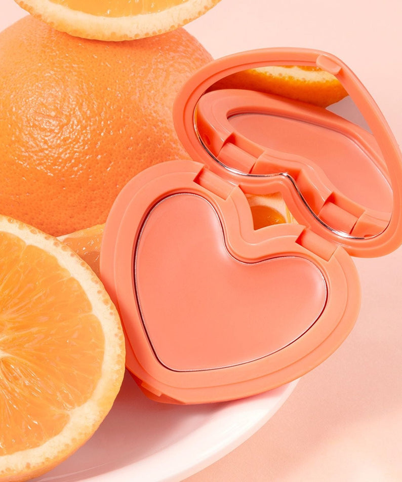 LILYBYRED Love Beam Cheek Balm in heart-shaped compact with oranges
