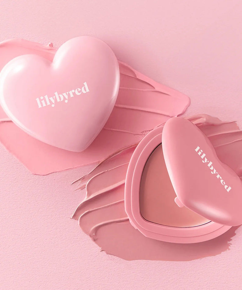 LILYBYRED Love Beam Cheek Balm in heart-shaped blush container on pink background