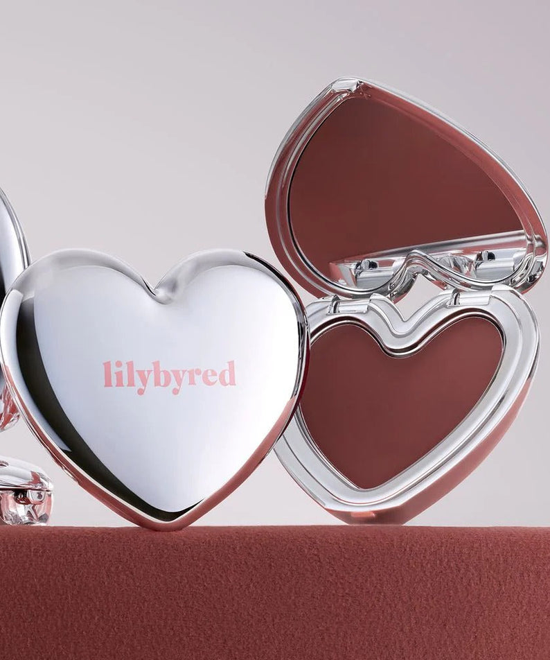 Heart-shaped LILYBYRED Love Beam Cheek Mousse compact with burgundy blush shade
