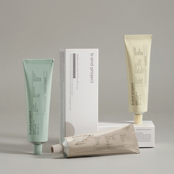 Assorted skincare tubes and packaging displayed in a minimalist setting