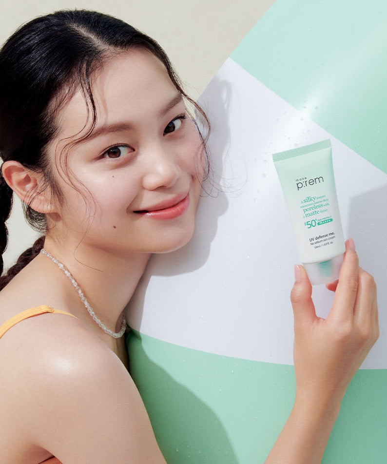 Woman holding MAKE P:REM UV Defense Me No-Sebum Sunscreen 50ml by a poolside.