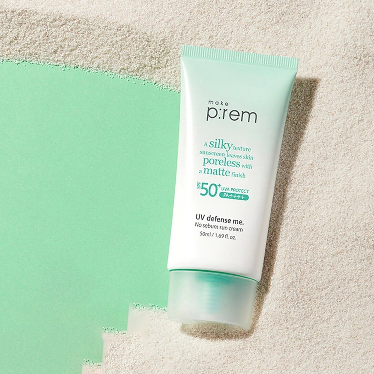 MAKE P:REM UV Defense Me No-Sebum Sunscreen 50ml tube on sand background