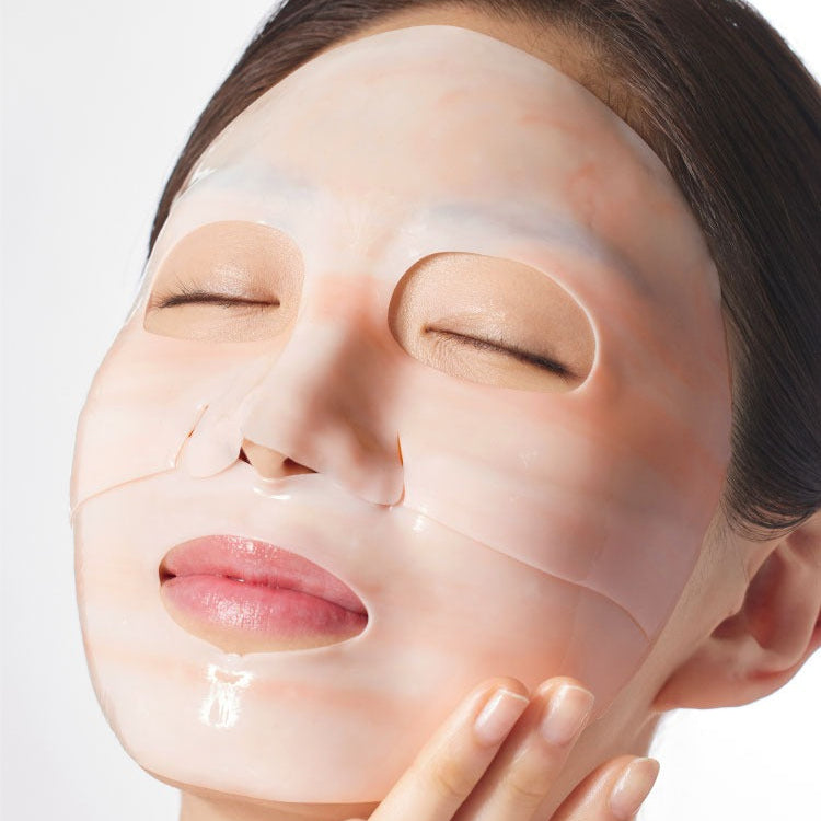 Person using MAMONDE Flora Glow Rose Marble Pack face mask.