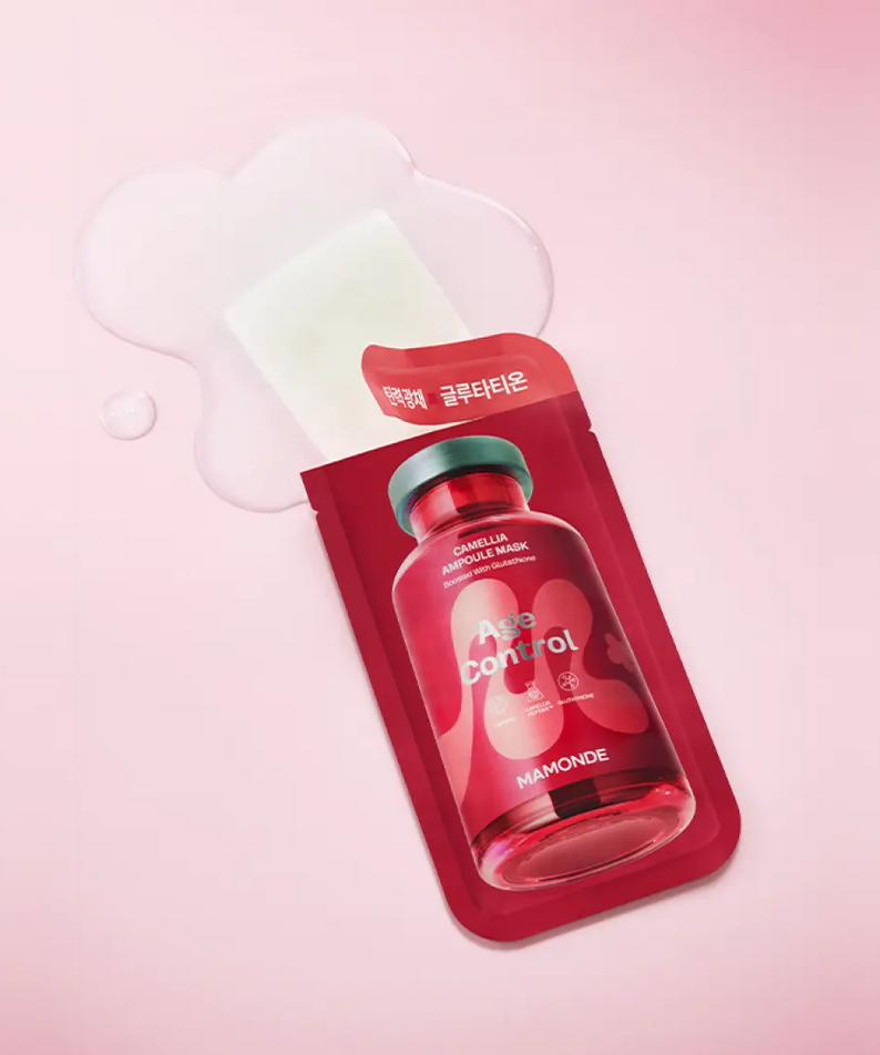 MAMONDE Age Control Camellia Ampoule Mask Pack packaging on a pink background with liquid splashes.