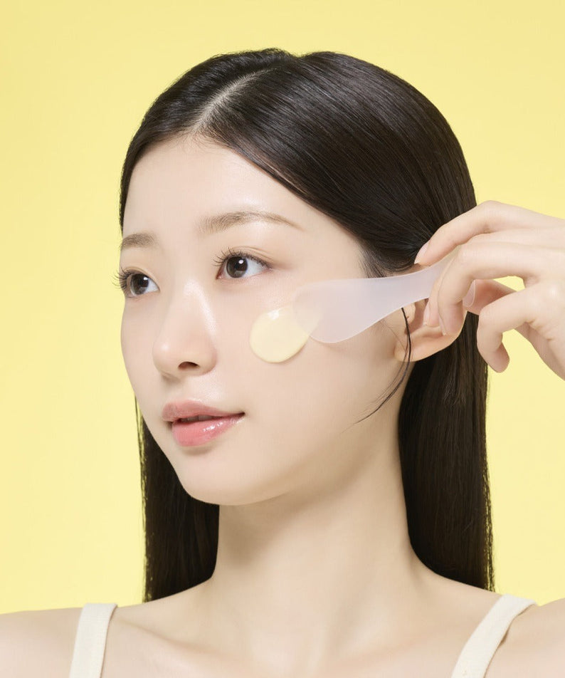 Woman applying MAMONDE Original Recipe Honey Modeling 1 Pack on face with spatula, skincare routine, yellow background