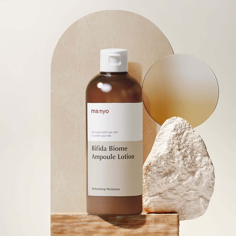 MANYO Bifida Biome Ampoule Lotion 300ml displayed against a stone backdrop, showcasing its refreshing moisture formula in a 300ml bottle.