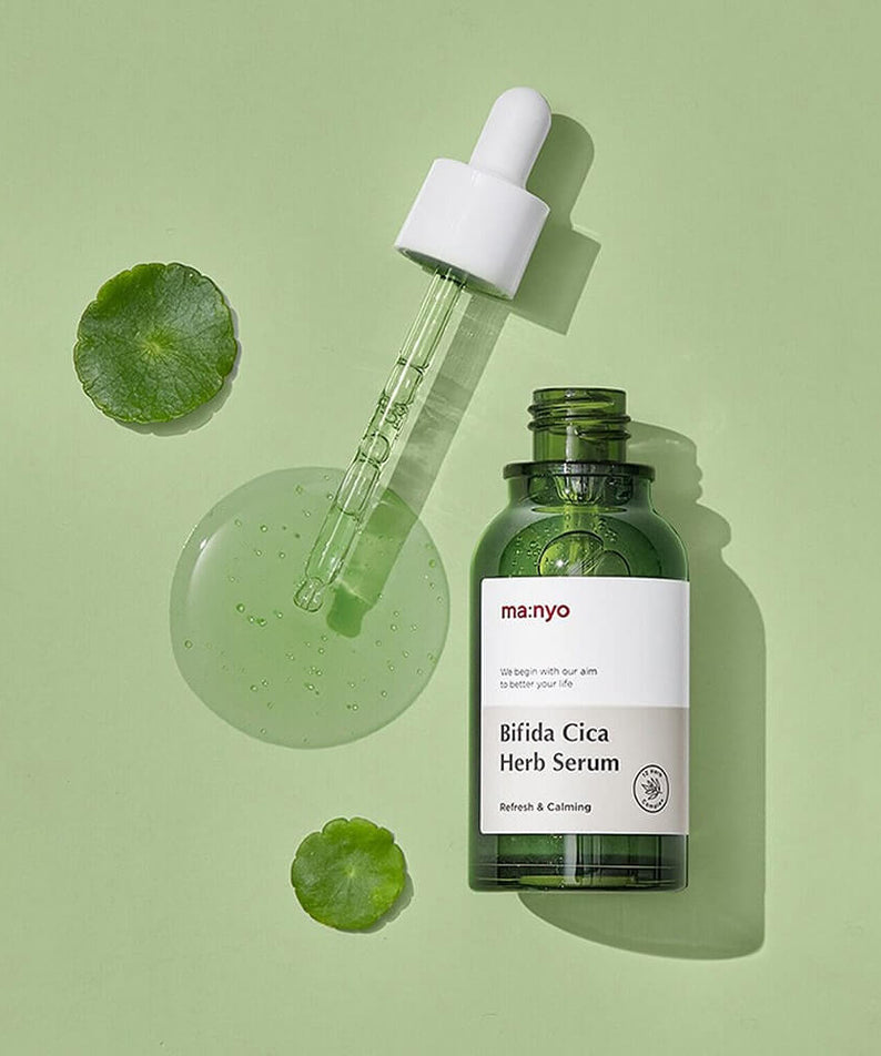MANYO Bifida Cica Herb Serum 50ml bottle with dropper on green background showcasing skincare product.