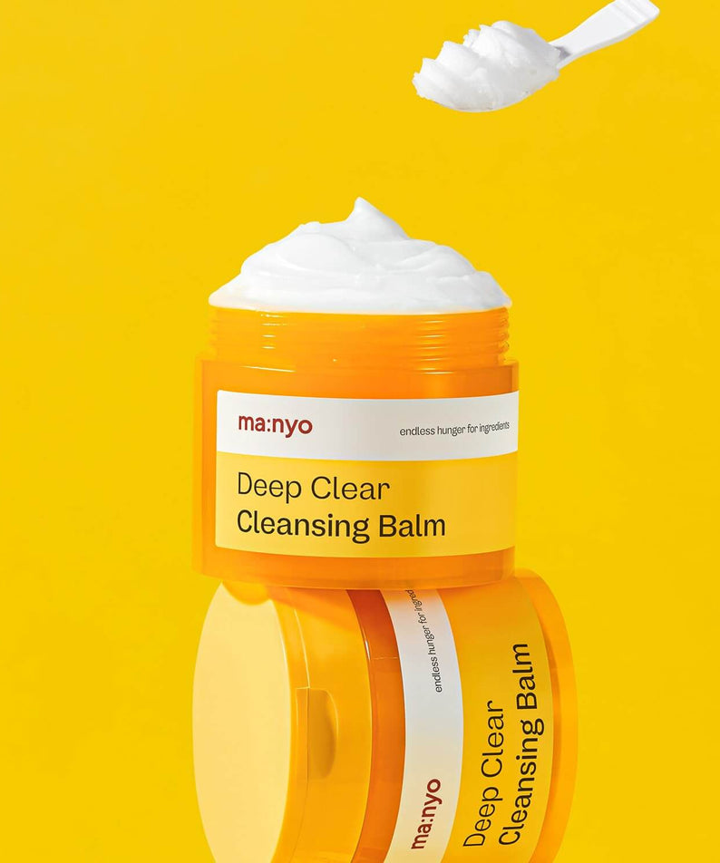 MANYO Deep Clear Cleansing Balm 132ml in vibrant yellow container with smooth balm texture, featured on a yellow background.