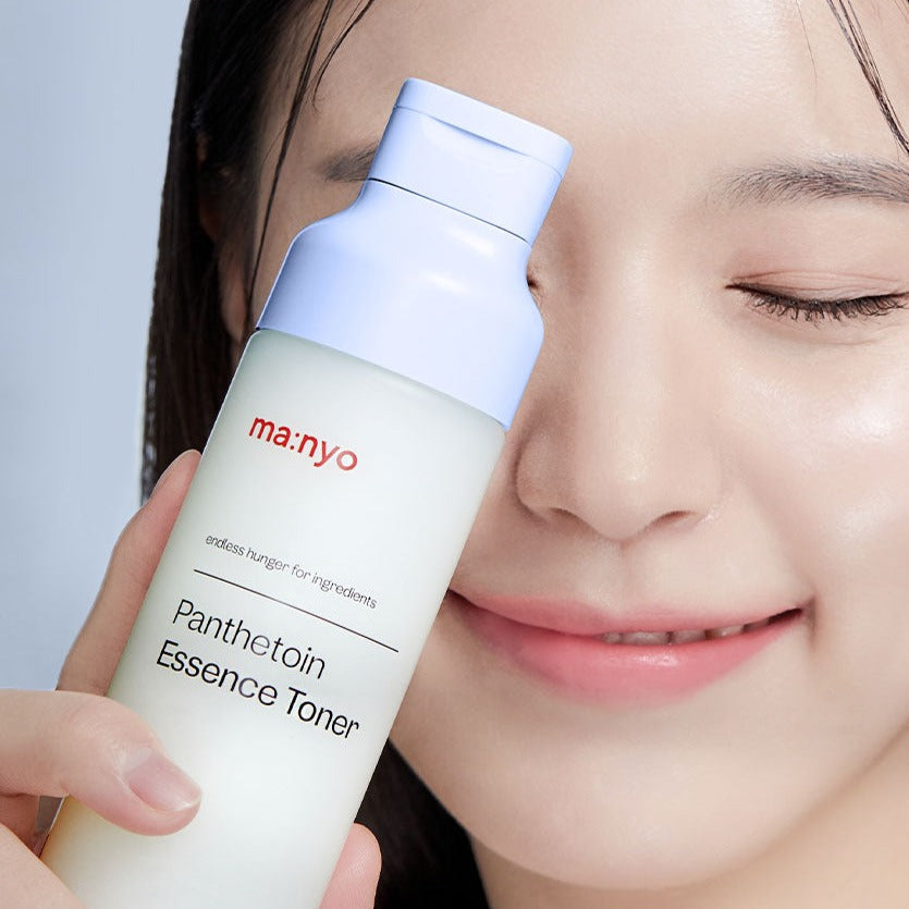 MA:NYO Panthetoin Essence Toner 200ml being held by a person with radiant skin