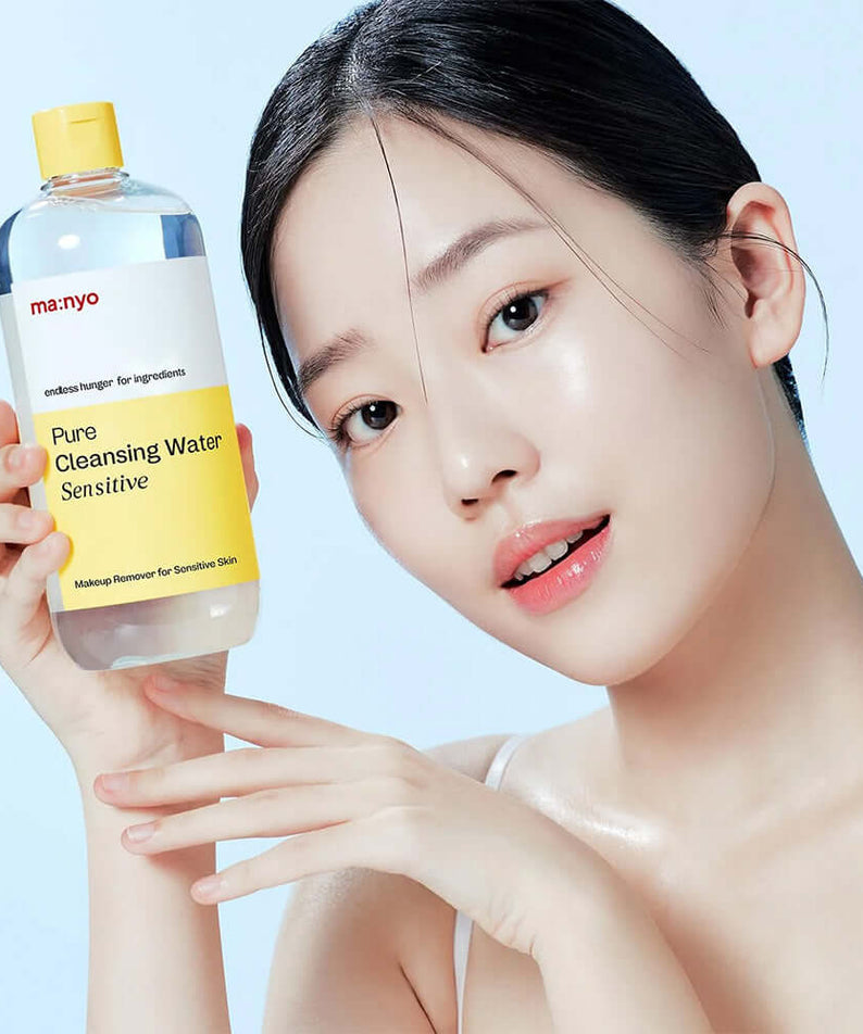Woman holding MANYO Pore Cleansing Water Sensitive 500ml for sensitive skin cleansing