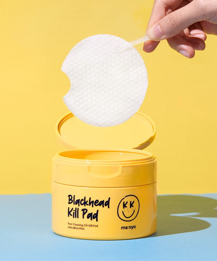 MA:NYO Blackhead Pure Cleansing Kill Pad 50p container with pad being lifted by a hand against a yellow background.