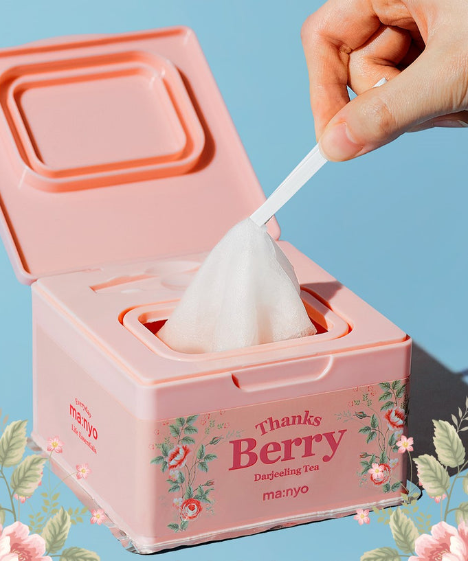 MA:NYO Thanks Berry Darjeeling Tea Facial Mask 310ml pack with floral design, showing hand using a facial mask wipe.