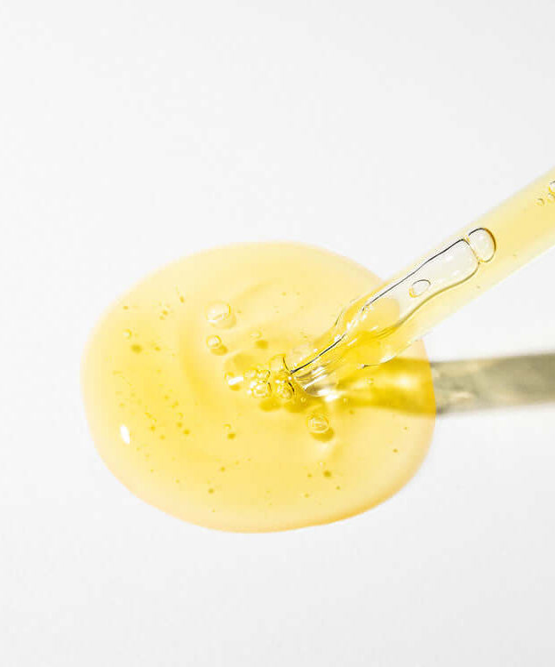 MARY & MAY Idebenone+Blackberry Complex Serum with dropper and serum texture on white background