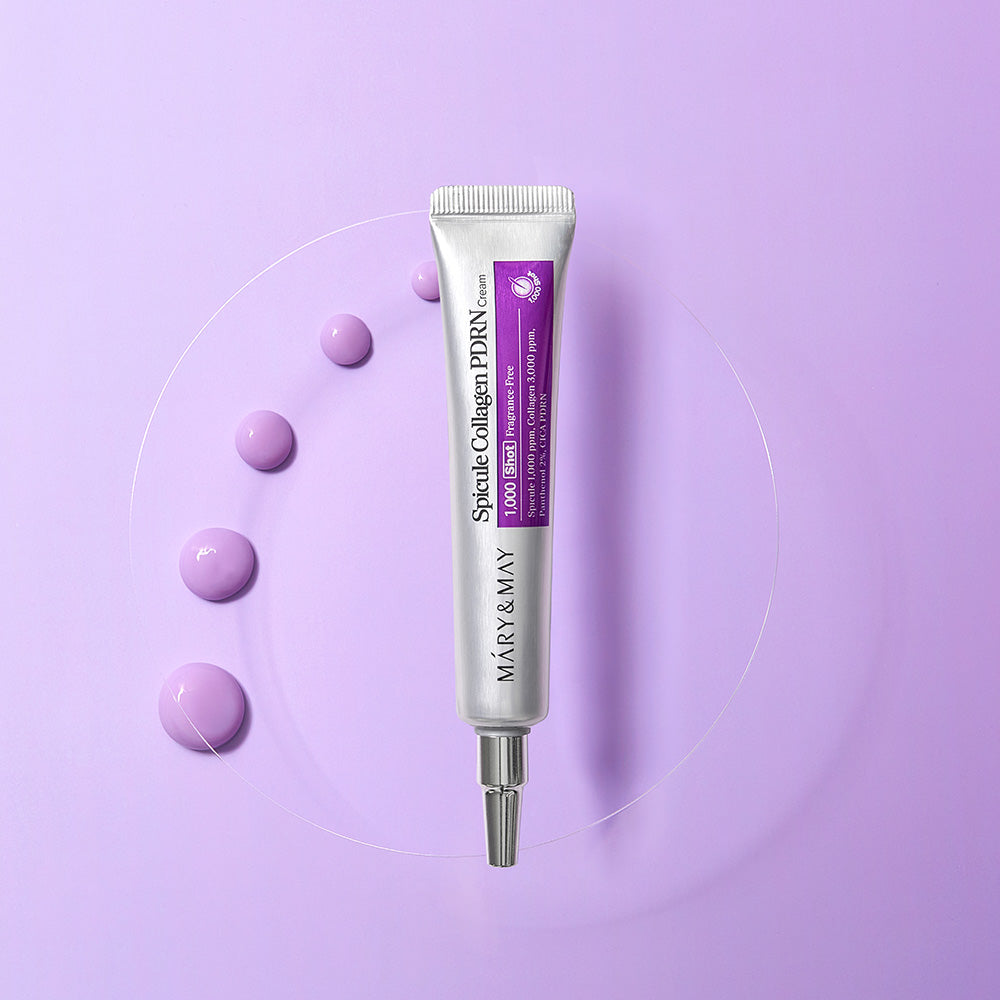 MARY&MAY Speckle Collagen PDRN Cream 15g tube on a purple background with cream droplets