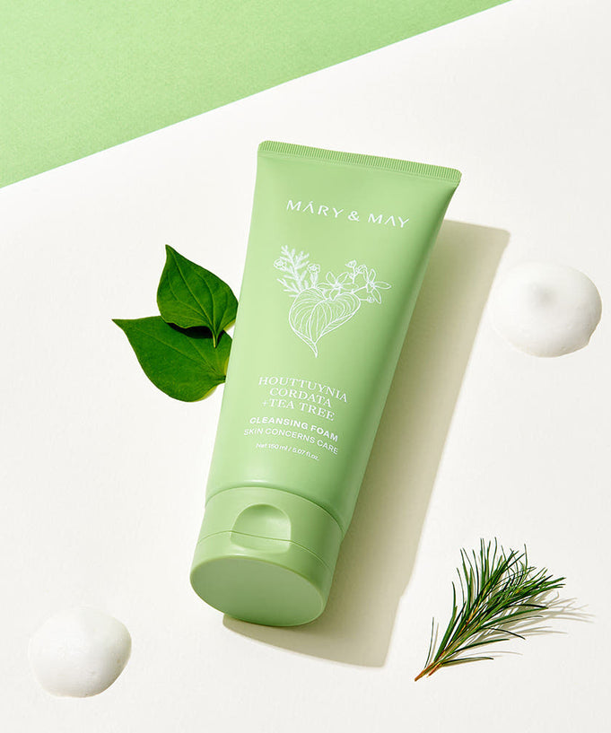 MARY&MAY Tea Tree Pore Cleansing Foam 150ml with natural ingredients, product image showing green tube next to botanical elements.