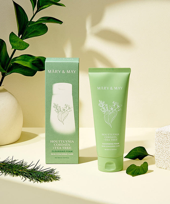 MARY&MAY Tea Tree Pore Cleansing Foam 150ml with packaging, displayed with green leaves and natural light background.