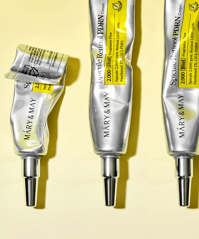Three tubes of MARY&MAY Speculum Retinol PDRN Cream 15g on a yellow background