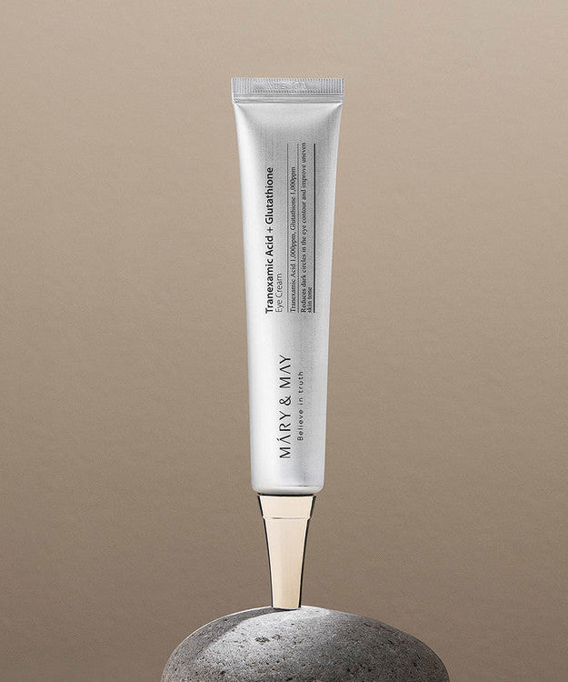 MARY&MAY Tranexamic Acid Glutathione Eye Cream 30ml tube displayed on stone background