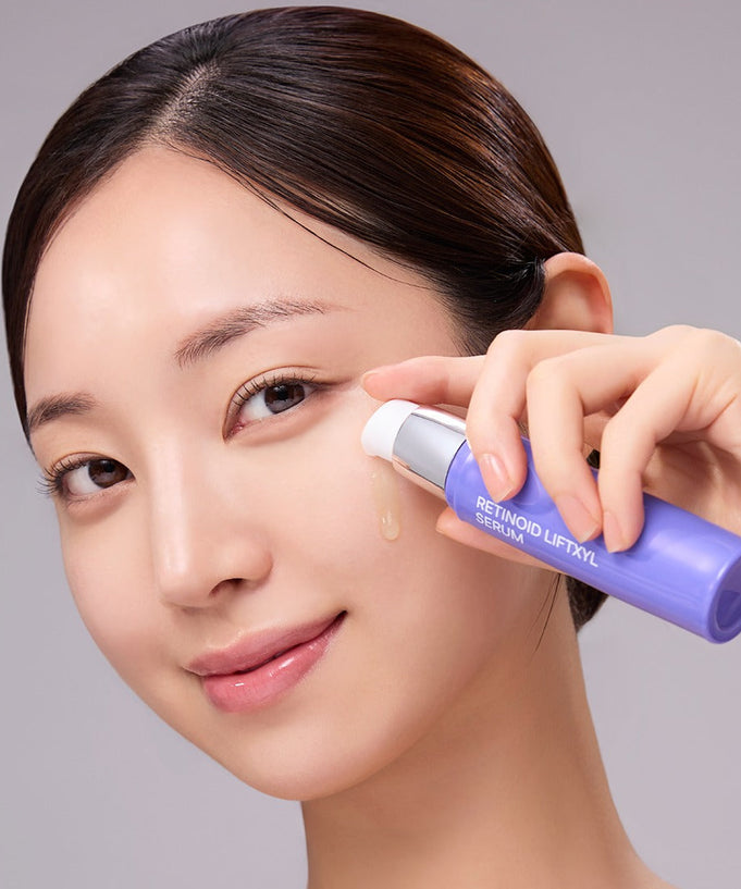 Woman applying MEDIANSWER Retinoid Liftsil Serum 30ml to her face for skincare routine.