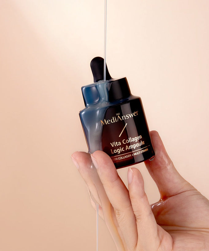 Hand holding MEDIANSWER Vita Collagen Logic Ampoule bottle on peach background