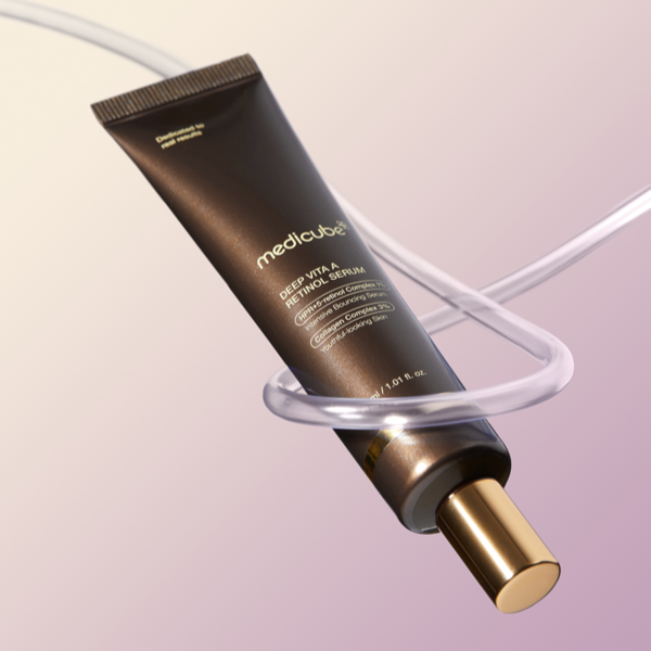 MEDICUBE Deep Vita A Retinol Serum 30ml in sleek tube with gold cap on pastel background