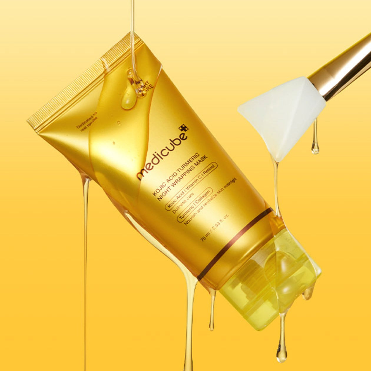 MEDICUBE Kojic Acid Turmeric Vita Wrapping Mask 75ml tube with dripping texture and spatula on yellow background.
