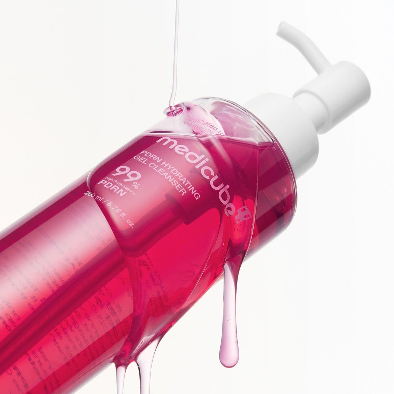 MEDICUBE PDRN Gel-To-Foam Cleanser 200ml bottle with pink liquid, angled view, emphasizing product design and bottle features.