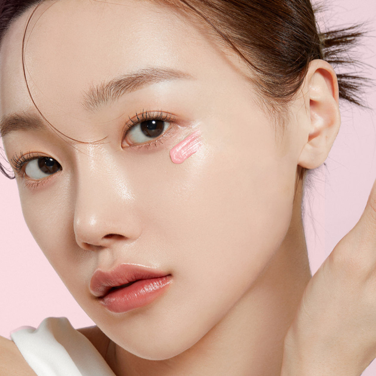 Model applying MEDICUBE PDRN Pink Peptide Eye Cream 30ml on face for skincare