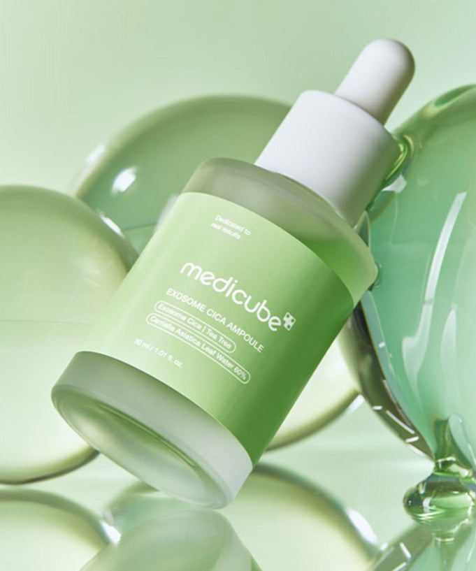 MEDICUBE Exosome Cica Ampoule 30ml skincare serum bottle on green background.