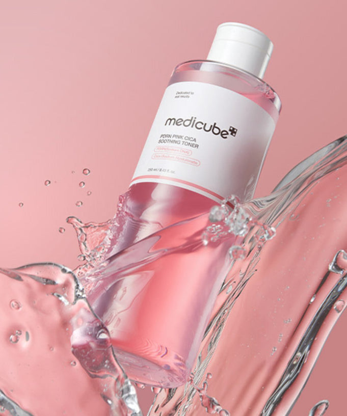 MEDICUBE PDRN Pink Cica Soothing Toner 250ml in splash effect with pink background