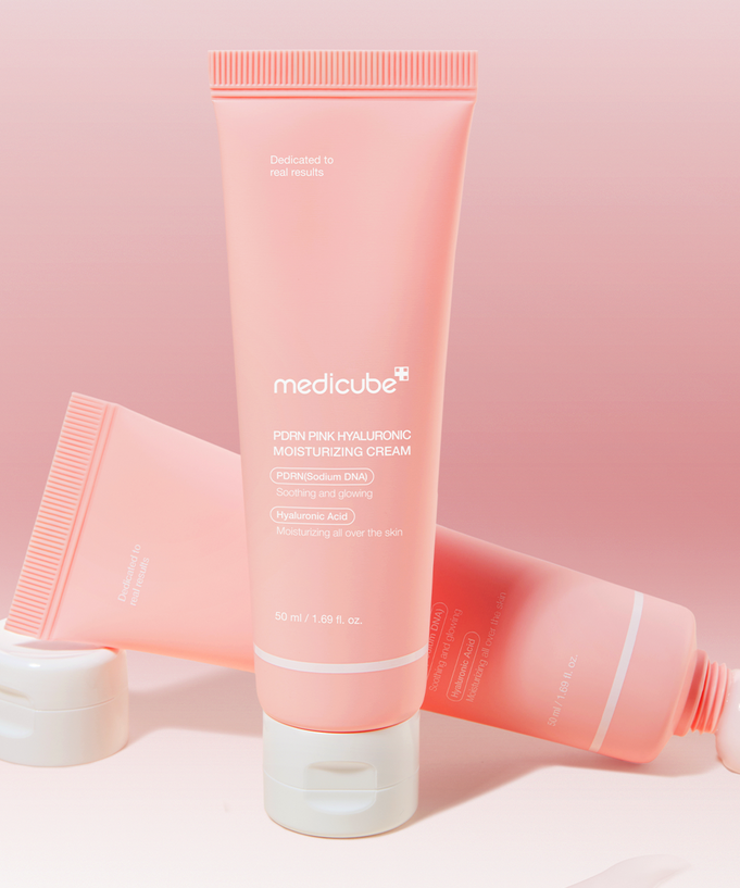 MEDICUBE PDRN Pink Hyaluronic Moisturizing Cream 50ml in a pink tube with white cap displayed against a matching pink background.
