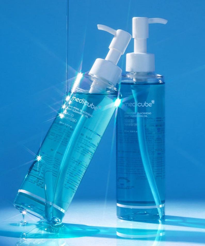 Two bottles of MEDICUBE Zero Pore Blackhead Deep Cleansing Oil 205ml with a vibrant blue background.